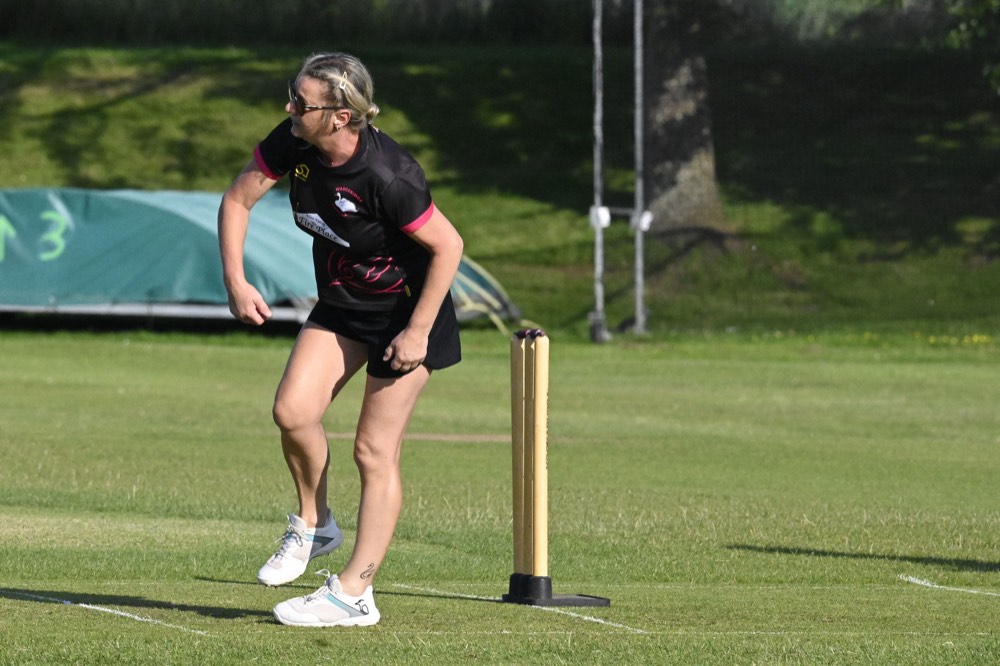 A Wadebridge player backing up at the non-striker's end on a summer evening at Egloshayle.